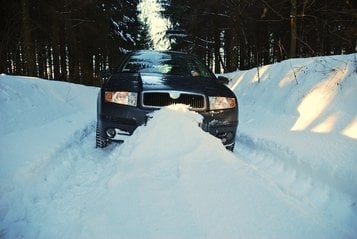 car-trapped-in-the-snow-on-a-winter-road-1250643